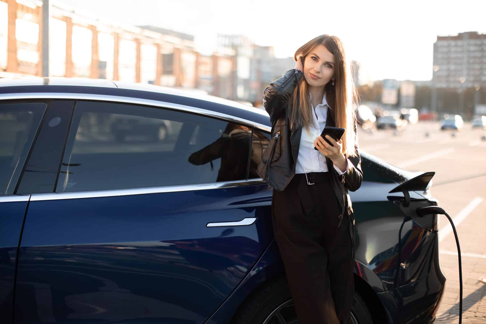 Woman charging electric car