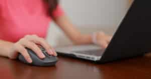 Woman work on computer with mouse at office
